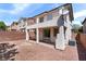 View of the backyard featuring a patio, stucco walls, and second-story balcony at 10713 Noble Mesa Ave, Las Vegas, NV 89166
