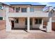 Backyard patio with white stucco columns and upper level balcony at 10713 Noble Mesa Ave, Las Vegas, NV 89166