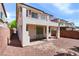 View of the backyard featuring a patio, stucco walls, and second-story balcony at 10713 Noble Mesa Ave, Las Vegas, NV 89166