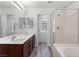 This bathroom features a dual sink vanity, a glass-enclosed shower, and warm lighting, creating a relaxing oasis at 10713 Noble Mesa Ave, Las Vegas, NV 89166