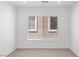 Clean bedroom with neutral carpet, white walls, and a window to let in natural light at 10713 Noble Mesa Ave, Las Vegas, NV 89166