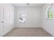 A bright bedroom features neutral carpet and a large closet, as well as windows, providing plenty of light at 10713 Noble Mesa Ave, Las Vegas, NV 89166