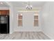 Dining room with light wood flooring, chandelier, and natural light from two windows at 10713 Noble Mesa Ave, Las Vegas, NV 89166