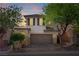 Charming two-story home with a brick driveway and well-maintained landscaping at sunset at 10713 Noble Mesa Ave, Las Vegas, NV 89166