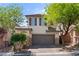 Exterior of a two story home with an attached two car garage and lush landscaping at 10713 Noble Mesa Ave, Las Vegas, NV 89166
