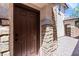Close-up of front door, stone entrance, and brick paved walkway in a welcoming facade at 10713 Noble Mesa Ave, Las Vegas, NV 89166