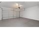 Clean garage with an epoxy floor and a white insulated garage door at 10713 Noble Mesa Ave, Las Vegas, NV 89166