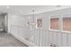 Upstairs hallway with bright white railing, neutral carpet, and many windows for natural light at 10713 Noble Mesa Ave, Las Vegas, NV 89166