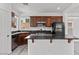Contemporary kitchen showcasing stainless steel appliances, a breakfast bar, and an efficient layout at 10713 Noble Mesa Ave, Las Vegas, NV 89166