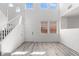 Open-concept living room with high ceilings, light wood flooring, and staircase at 10713 Noble Mesa Ave, Las Vegas, NV 89166