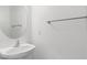 A well-lit, simple powder room with a floating sink, a towel rack, and an oval mirror at 10713 Noble Mesa Ave, Las Vegas, NV 89166