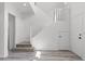 Bright foyer with all-white staircase, neutral carpet, and contemporary wood-look flooring at 10713 Noble Mesa Ave, Las Vegas, NV 89166