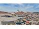 Expansive aerial view showcasing the community, mountains in the distance, and home's location at 1125 Via Canale Drive at 1125 Via Canale Dr, Henderson, NV 89011