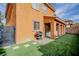 Spacious backyard with artificial turf, covered patio, grill, perfect for outdoor living at 1125 Via Canale Dr, Henderson, NV 89011