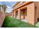Backyard featuring a covered patio, artificial turf, and privacy wall at 1125 Via Canale Dr, Henderson, NV 89011