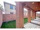 Covered patio with brick pillars overlooks backyard with artificial turf at 1125 Via Canale Dr, Henderson, NV 89011