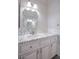 Bathroom sink and vanity with decorative mirror and marble countertop at 1125 Via Canale Dr, Henderson, NV 89011
