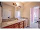 Bathroom boasts dual sinks, granite counters, wood cabinets and an entry to a pink themed bedroom at 1125 Via Canale Dr, Henderson, NV 89011