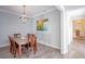 Dining room features modern chandelier and stylish decor with convenient access to the stairway at 1125 Via Canale Dr, Henderson, NV 89011