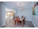 Charming dining room with chandelier lighting and a view to the kitchen at 1125 Via Canale Dr, Henderson, NV 89011