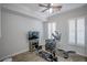 A well-lit exercise room features an elliptical machine, weight bench, and a television at 1125 Via Canale Dr, Henderson, NV 89011