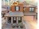 Two-story home featuring a tile roof, a covered front porch with stone pillars, and a two car garage at 1125 Via Canale Dr, Henderson, NV 89011