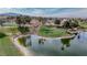 Picturesque view of the golf course with a pond and lush greenery, perfect for golf enthusiasts at 1125 Via Canale Dr, Henderson, NV 89011