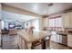 Bright kitchen with stainless steel appliances and an island overlooks an open-concept living room area at 1125 Via Canale Dr, Henderson, NV 89011