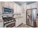 Gourmet kitchen with stainless steel appliances, custom cabinets, and granite countertops at 1125 Via Canale Dr, Henderson, NV 89011