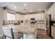 Spacious kitchen features granite countertops, a center island, stainless steel appliances, and custom cabinets at 1125 Via Canale Dr, Henderson, NV 89011