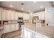 Spacious kitchen features granite countertops, a center island, stainless steel appliances, and custom cabinets at 1125 Via Canale Dr, Henderson, NV 89011