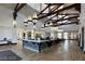 A grand lobby features a reception desk, soaring ceilings with exposed beams, and contemporary lighting fixtures at 1125 Via Canale Dr, Henderson, NV 89011