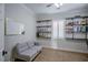 Versatile home office features a comfortable gray couch and custom shelves for organizing supplies at 1125 Via Canale Dr, Henderson, NV 89011