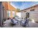 Cozy patio with outdoor seating, string lights, and decorative fountain, ideal for relaxing at 1125 Via Canale Dr, Henderson, NV 89011