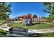 Colorful playground with climbing structures, slides, and soft turf, perfect for outdoor fun at 1125 Via Canale Dr, Henderson, NV 89011