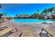 Resort-style pool area with palm trees, lounge chairs, and a lifeguard stand for relaxation and recreation at 1125 Via Canale Dr, Henderson, NV 89011