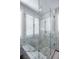 Glass shower with a marble bench, walls and floor in a modern bathroom at 1125 Via Canale Dr, Henderson, NV 89011