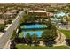 Aerial view of the community's tennis courts and clubhouse with a pool, offering recreational amenities at 1125 Via Canale Dr, Henderson, NV 89011