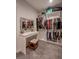 Well-organized walk-in closet featuring vanity area with mirror and stool, plus lots of space at 1125 Via Canale Dr, Henderson, NV 89011
