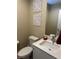 Powder room offers a modern vanity, decorative wall art, and a convenient toilet at 11257 Rainbow Peak Ave # 201, Las Vegas, NV 89135