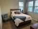 Cozy bedroom featuring a comfortable bed, chair, and bright natural light from nearby windows at 11257 Rainbow Peak Ave # 201, Las Vegas, NV 89135