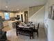Open concept dining area, adjacent to the kitchen, with a table, bench, and tile flooring at 11257 Rainbow Peak Ave # 201, Las Vegas, NV 89135