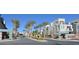 Scenic community entrance with palm trees and modern building architecture at 11257 Rainbow Peak Ave # 201, Las Vegas, NV 89135