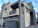 Modern home with eye-catching awnings, gray siding, and a convenient one-car garage for easy parking at 11257 Rainbow Peak Ave # 201, Las Vegas, NV 89135