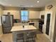 Bright kitchen featuring an island with quartz countertops and stainless steel appliances at 11257 Rainbow Peak Ave # 201, Las Vegas, NV 89135