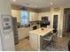 Stylish kitchen equipped with an island, stainless steel appliances, and ample cabinet space at 11257 Rainbow Peak Ave # 201, Las Vegas, NV 89135