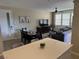 Open-concept living room with dining area and comfortable seating, great for entertaining guests at 11257 Rainbow Peak Ave # 201, Las Vegas, NV 89135