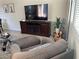 Cozy living room area with a large TV, comfortable seating, an acoustic guitar, and modern decor at 11257 Rainbow Peak Ave # 201, Las Vegas, NV 89135