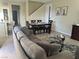 Spacious living room featuring comfortable sofa, table with chairs, and seamless flow into the kitchen at 11257 Rainbow Peak Ave # 201, Las Vegas, NV 89135