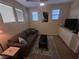 Second-floor loft featuring a comfortable sofa, TV, and ample natural light, perfect for relaxation at 11257 Rainbow Peak Ave # 201, Las Vegas, NV 89135